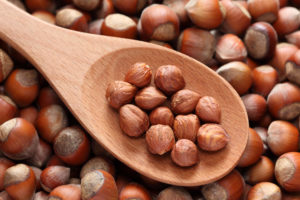 Hazelnuts in a wooden spoon