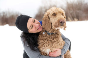 Goldendoodle with owner in snow