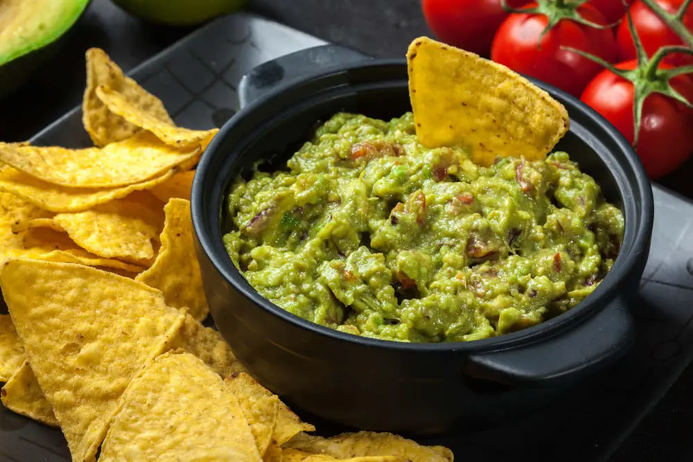 Guacamole with chips on table